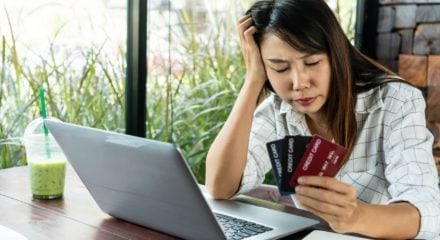 Young woman holding credit cards and wondering if debt consolidation is a good idea