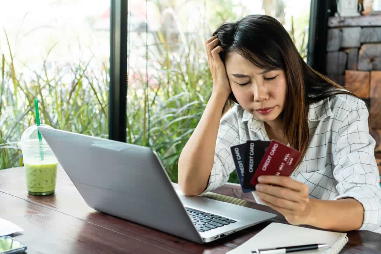 Young woman holding credit cards and wondering if debt consolidation is a good idea