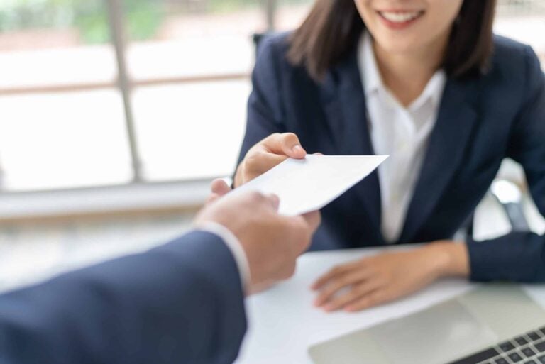 woman receiving piece of paper from someone