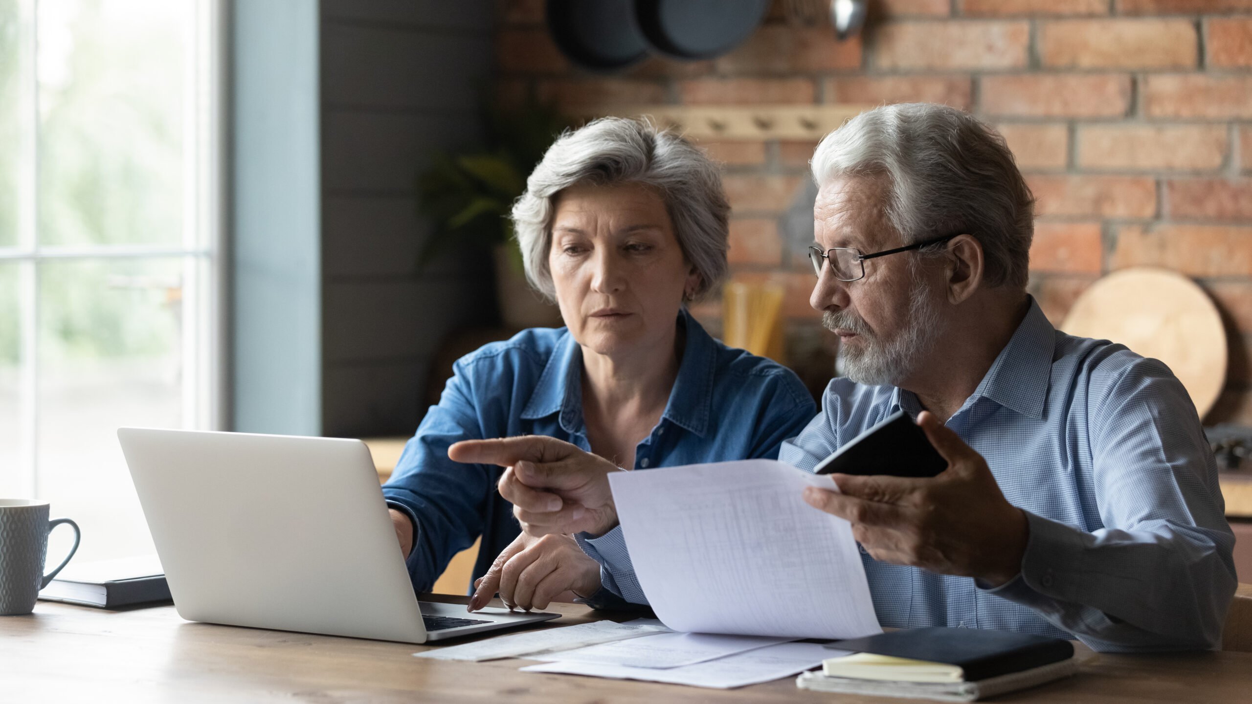 older man and woman looking at computer
