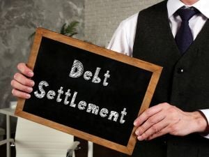 debt settlement written on small chalkboard