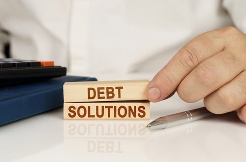 wood blocks that say debt solutions