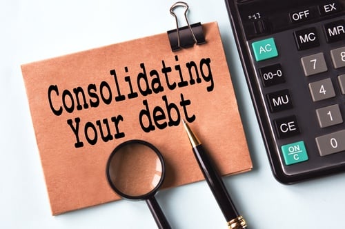 consolidating your debt sign next to a calculator