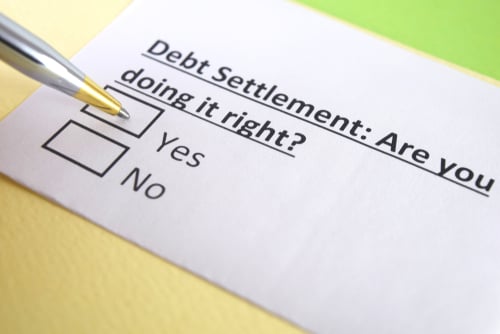 piece of paper with yes no check boxes asking if you are doing debt settlement right