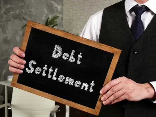 debt settlement written on small chalkboard