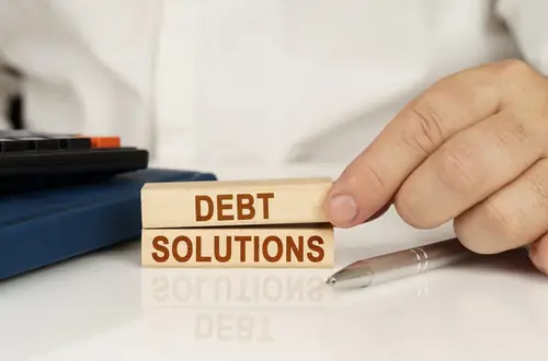 wood blocks that say debt solutions