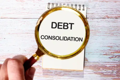 debt consolidation on notepad with magnifying glass
