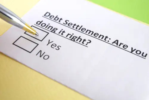 piece of paper with yes no check boxes asking if you are doing debt settlement right